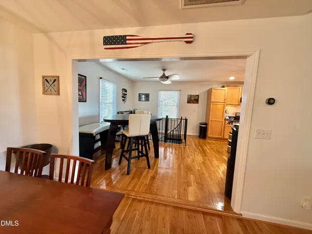 a kitchen with stainless steel appliances granite countertop a refrigerator a sink a stove and white cabinets