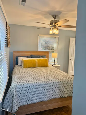 a bedroom with a bed and lamp with window