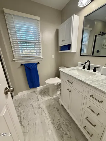 a view of a porch with furniture and wooden floor