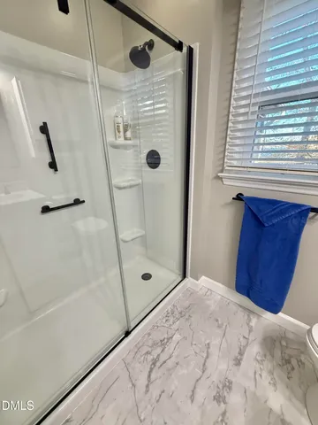 a view of a porch with furniture and wooden floor