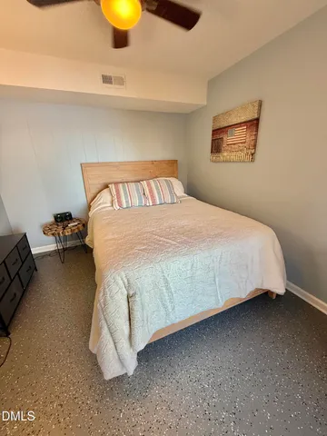 a bedroom with a bed and wall painting