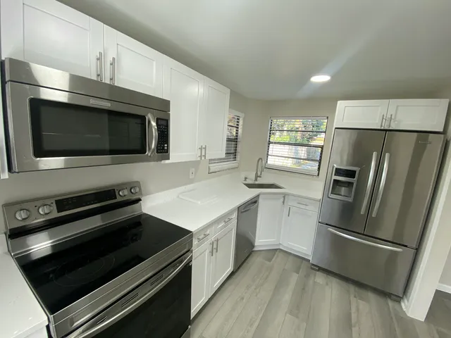 a kitchen with a refrigerator stove and microwave