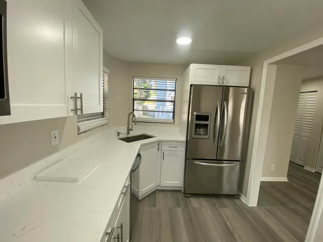 a kitchen with stainless steel appliances a refrigerator and a sink