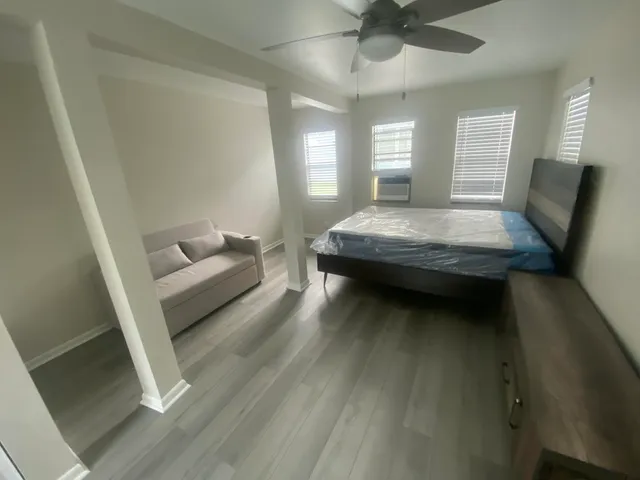 a living room with furniture and a wooden floor