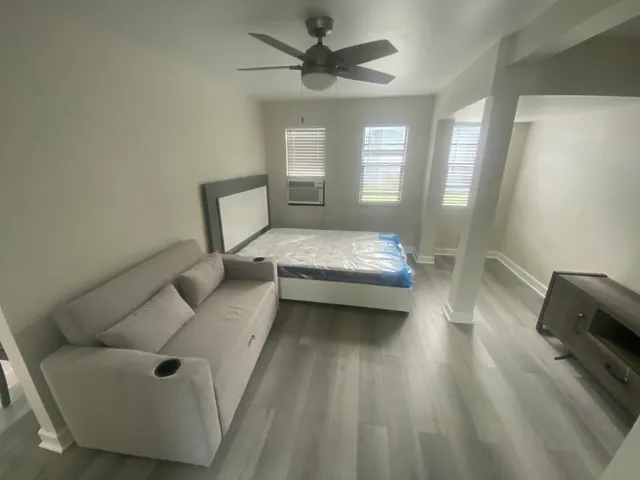 a bedroom with a bed and a couch