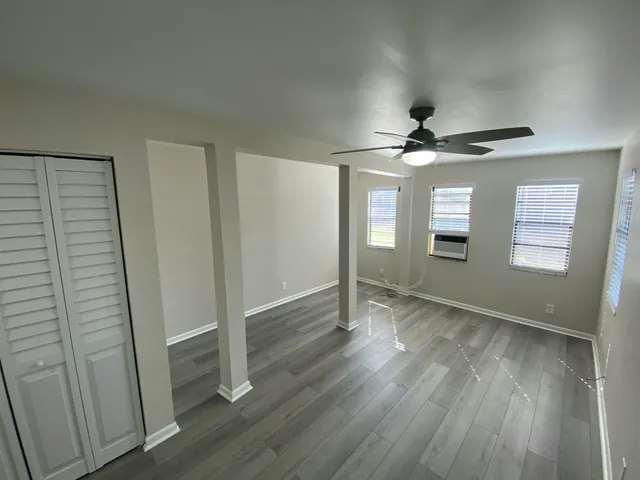 wooden floor in an empty room with a window