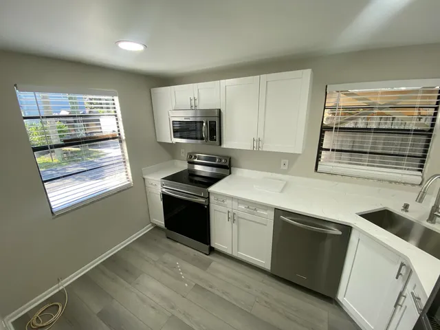 a kitchen with a stove and a microwave