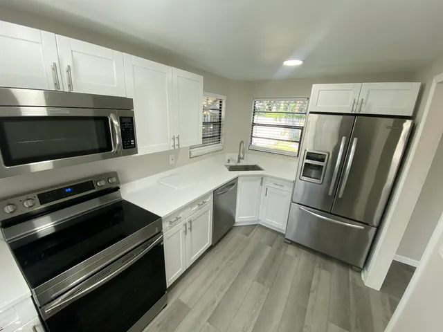 a kitchen with a refrigerator stove and microwave