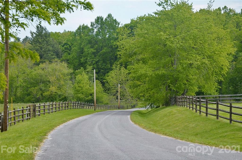 9999 Bishop Cove Road Fairview, NC 28730 - Photo 4 of 33 a view of a park with a fence and trees