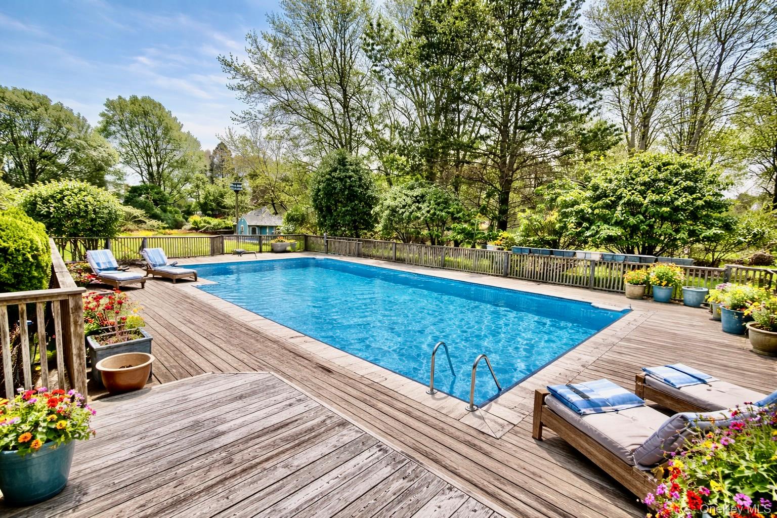 250 Paradise Point Road Southold, NY 11971 - Photo 16 of 24 a view of a patio with chairs and potted plants