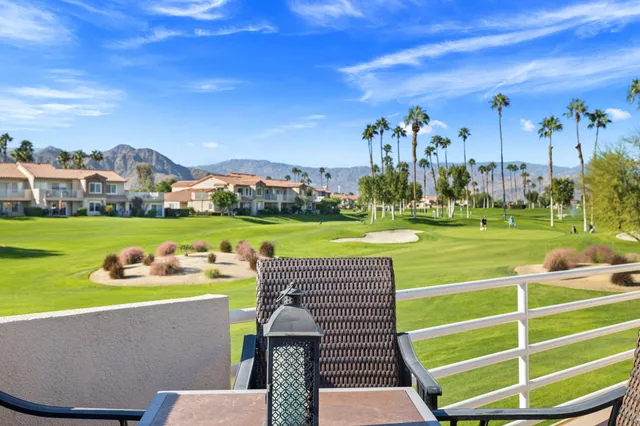 a view of a chairs and table in patio with a yard