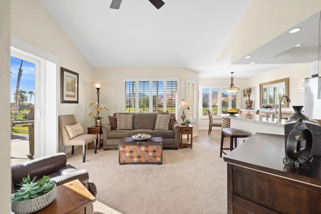 a view of a chairs and table in patio with a lake view