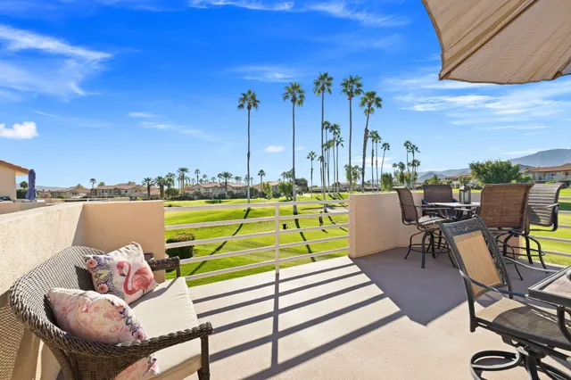 a view of a balcony with two chairs and a table