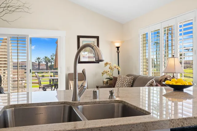 a kitchen with stainless steel appliances furniture dining table and wooden floor