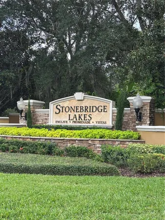 a sign that is sitting on a lush green field