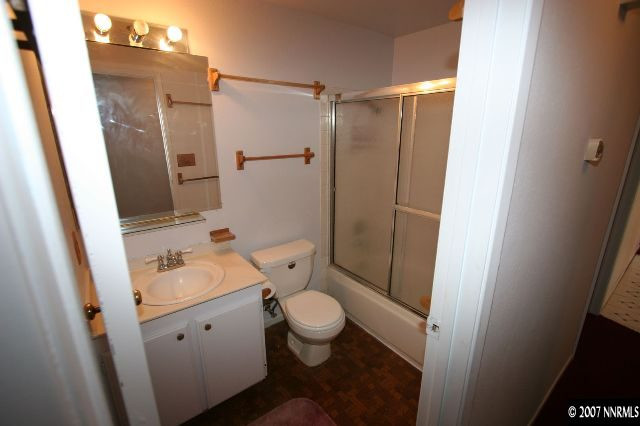 2897 Jake Street Reno, NV 89502 - Photo 4 of 5 a bathroom with a granite countertop sink toilet and shower