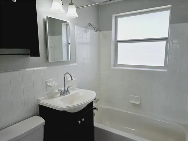a bathroom with a sink toilet tub and vanity