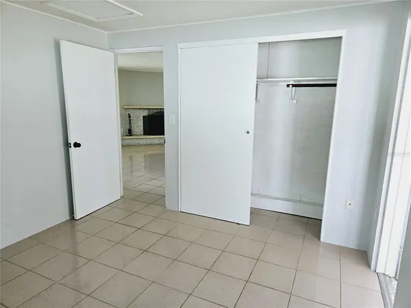 an empty room with a fireplace and windows