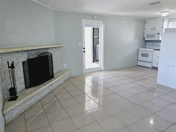 a view of a kitchen with cabinets and refrigerator