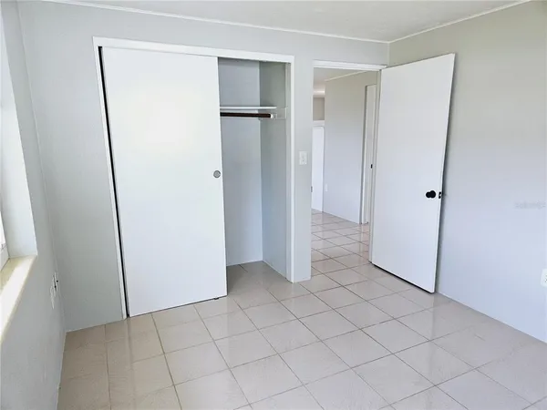 a view of a room with a refrigerator and cabinets