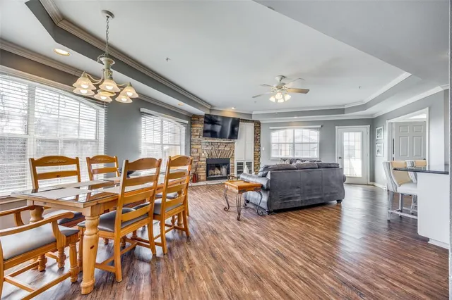 a living room with fireplace furniture and a wooden floor