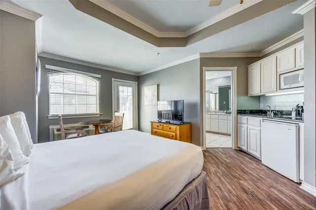 a large bedroom with a large bed and a large window