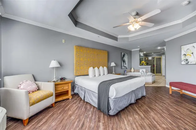 a bedroom with bed and a chandelier