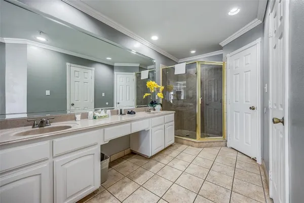 a bathroom with a double vanity sink mirror and shower