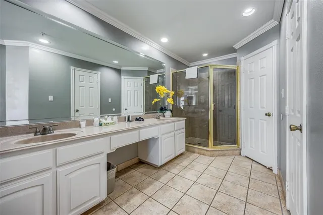 a bathroom with a double vanity sink mirror and shower