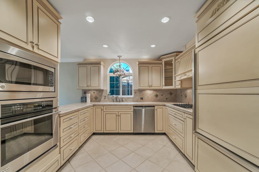9971 Broadmoor Drive San Ramon, CA 94583 - Photo 11 of 35 a large white kitchen with stainless steel appliances granite countertop a stove and a sink