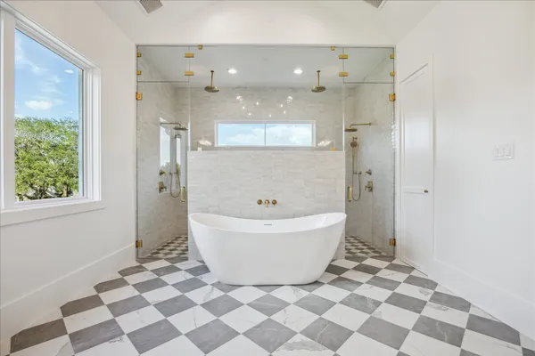 a bathroom with a bathtub and a shower