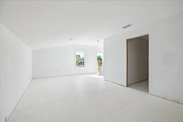 an empty room with windows and closet