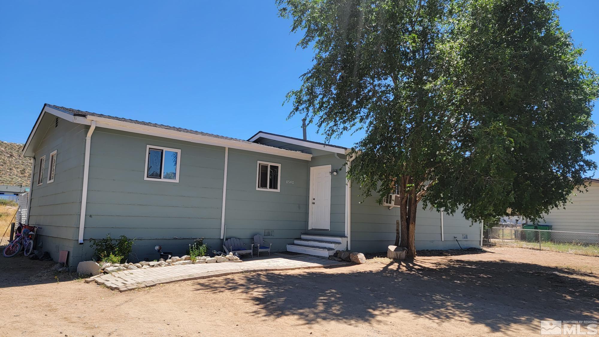 8540 Gate Street Reno, NV 89506 - Photo 1 of 17 a side view of a house with a yard