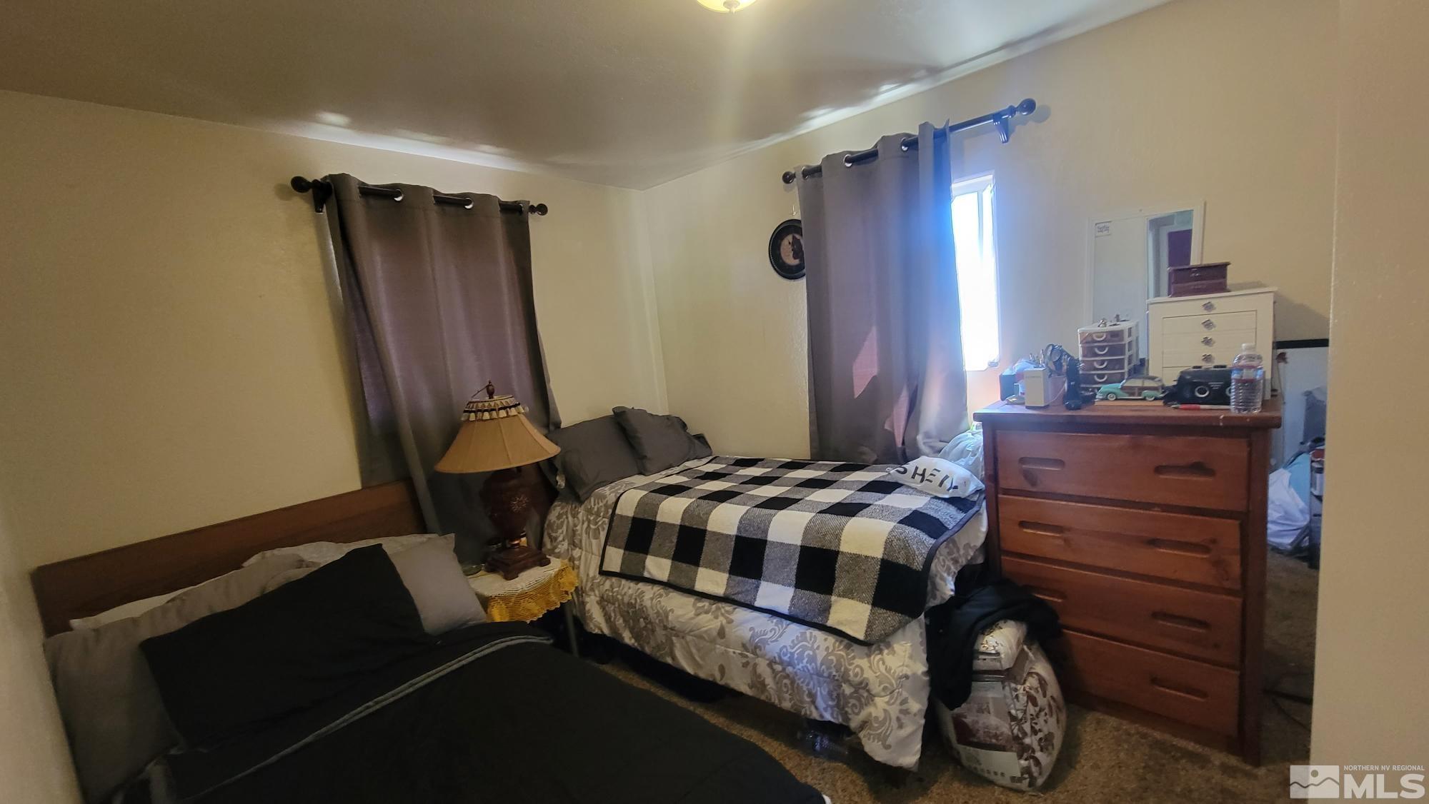 8540 Gate Street Reno, NV 89506 - Photo 8 of 17 a bedroom with a bed and a mirror