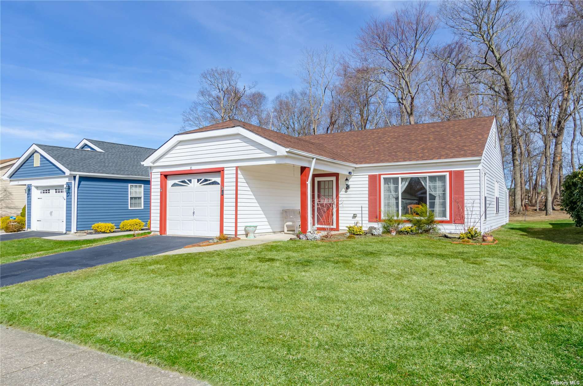 14 Lamont Road, Unit 14 Ridge, NY 11961 - Photo 1 of 1 a front view of a house with a yard and porch