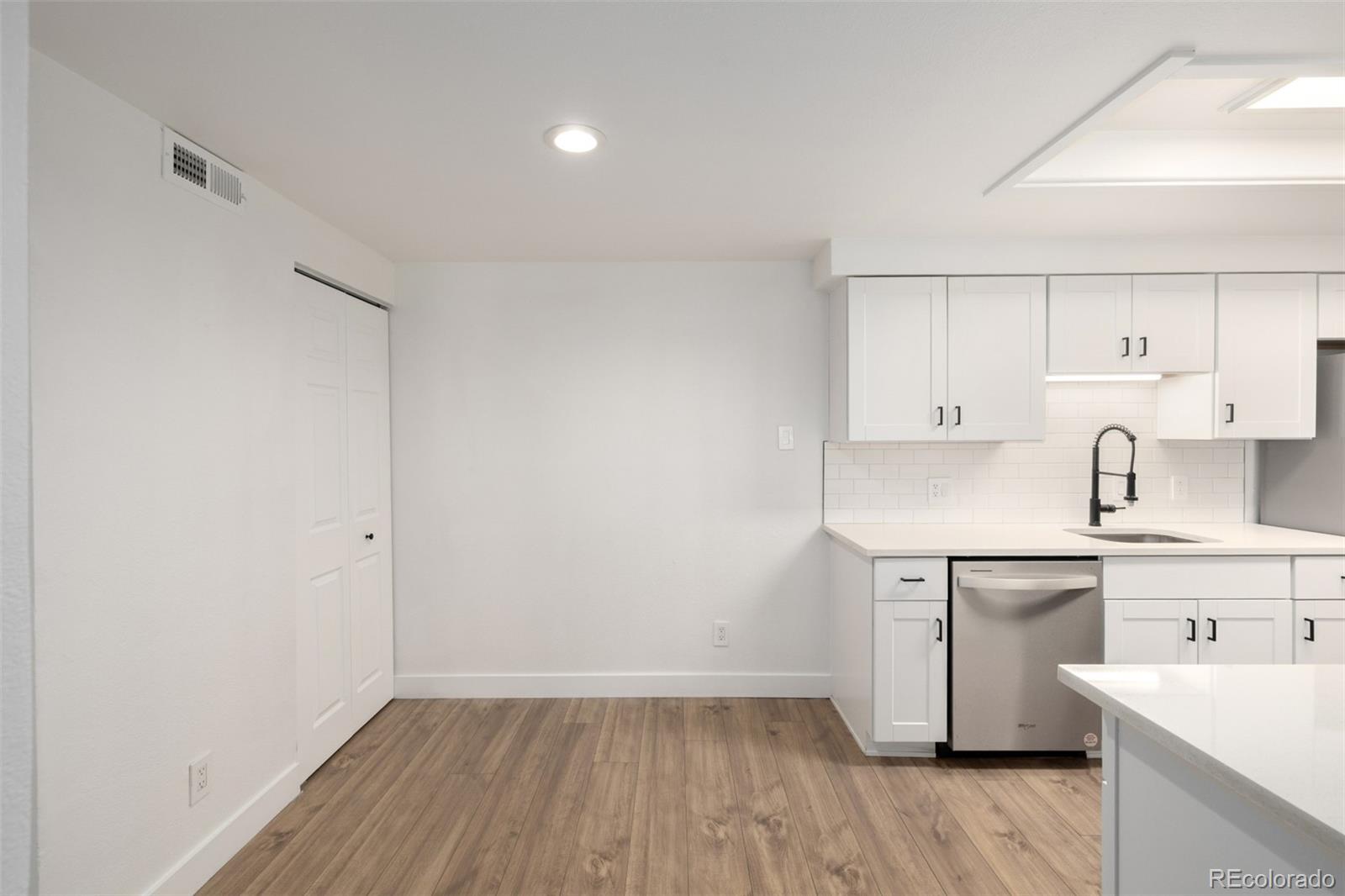 2929 West Floyd Avenue, Unit 201 Denver, CO 80236 - Photo 12 of 28 a view of a kitchen with wooden floor