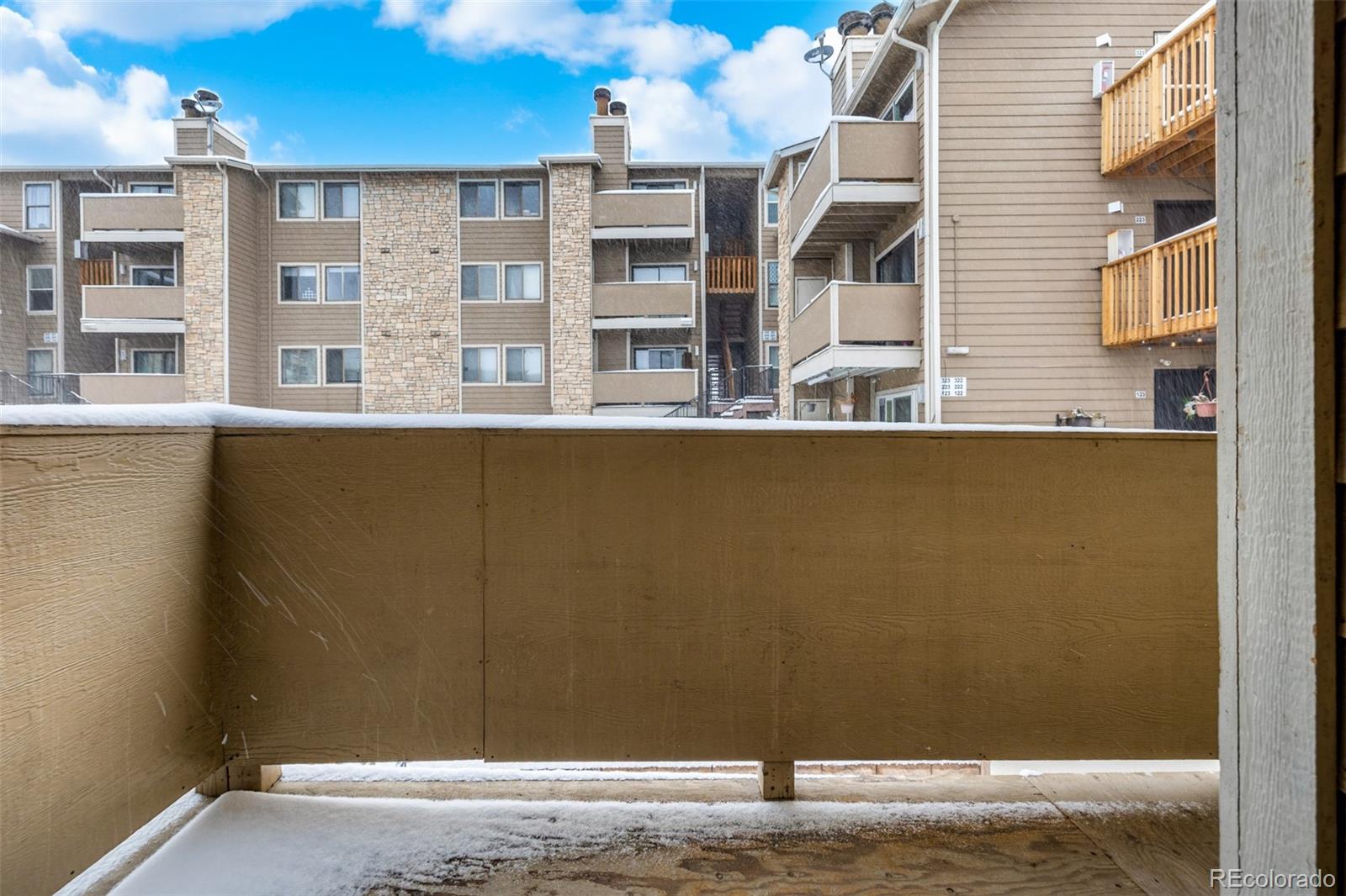 2929 West Floyd Avenue, Unit 201 Denver, CO 80236 - Photo 23 of 28 a view of a building from a balcony