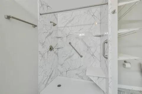 a bathroom with a shower and a shower
