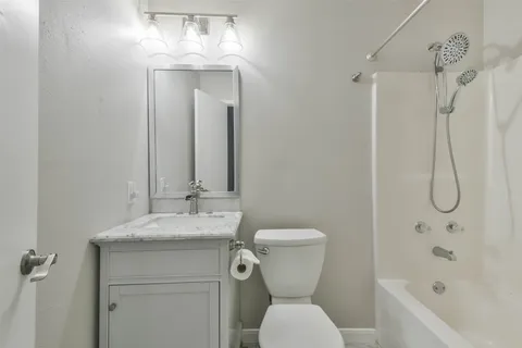 a bathroom with a sink toilet and shower