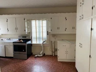 a kitchen with a stove and a refrigerator