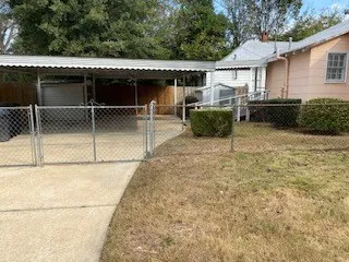 a view of a patio with table and chairs with wooden fence
