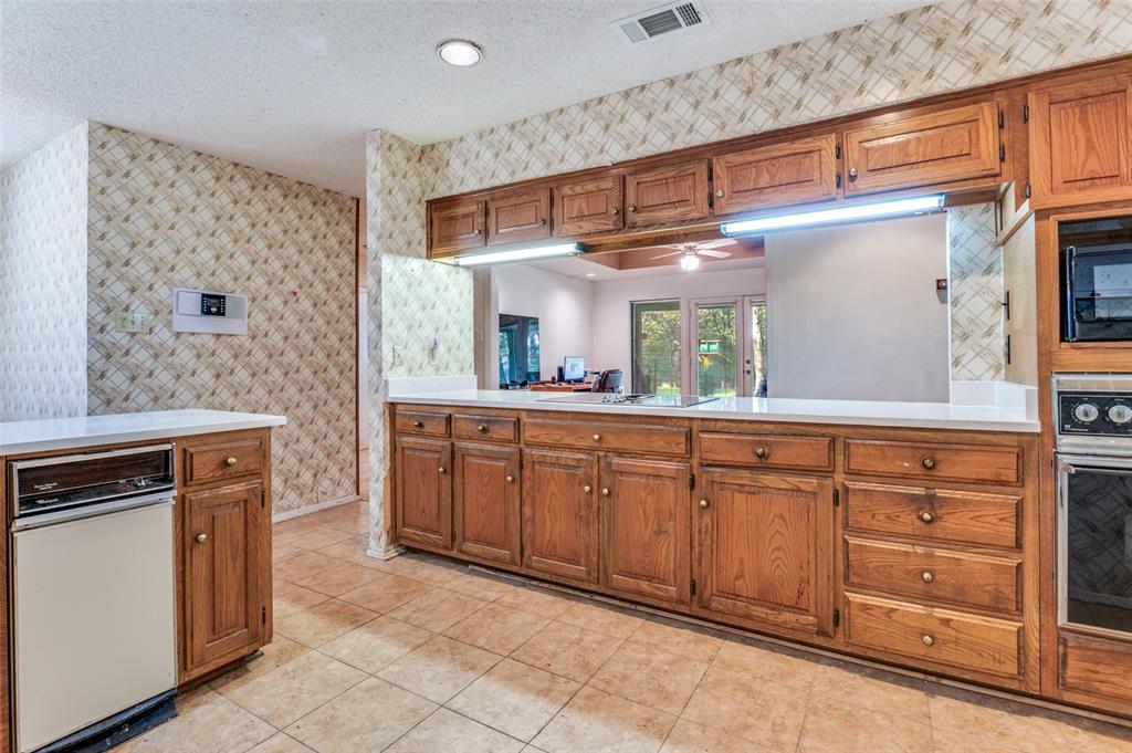 3008 Old Mill Run Grapevine, TX 76051 - Photo 14 of 38 a kitchen with granite countertop a sink and cabinets