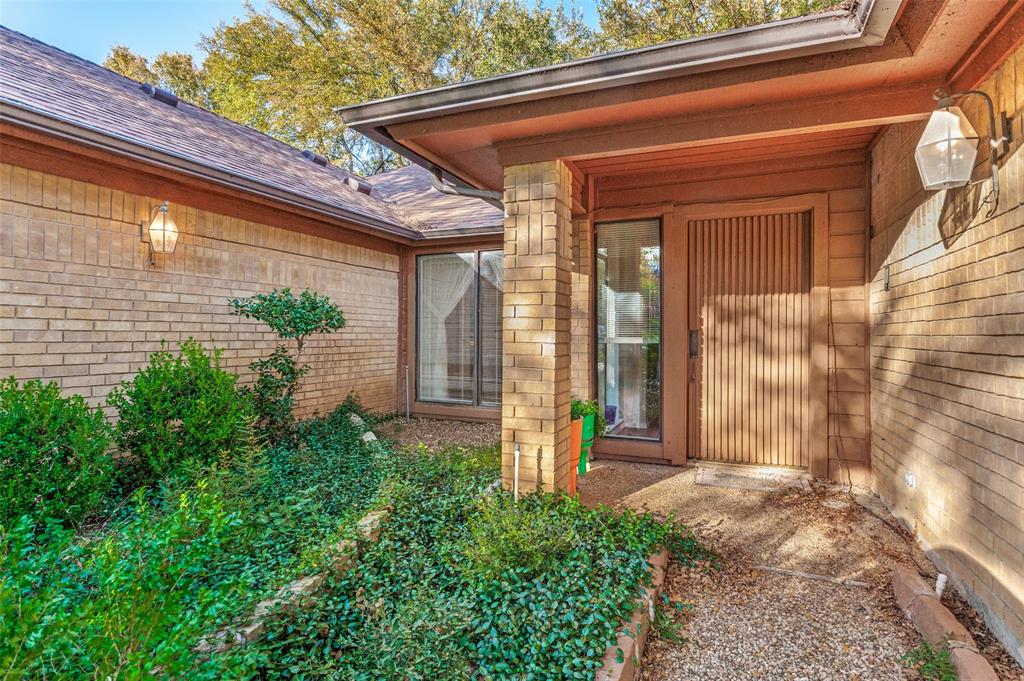 3008 Old Mill Run Grapevine, TX 76051 - Photo 2 of 38 a front view of a house with a garden