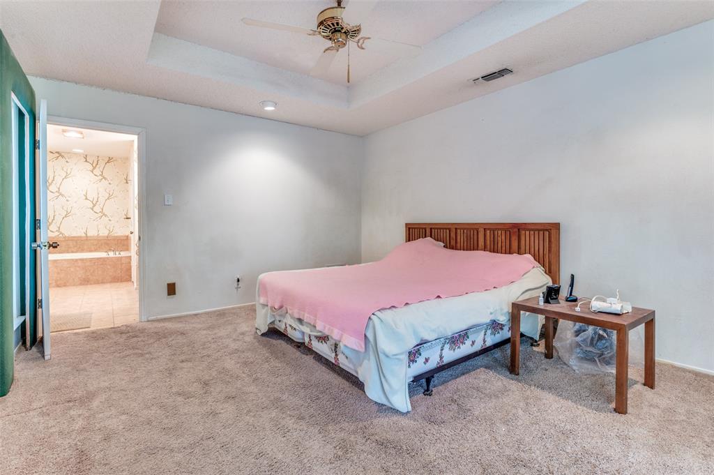 3008 Old Mill Run Grapevine, TX 76051 - Photo 21 of 38 a spacious bedroom with a bed and a chandelier