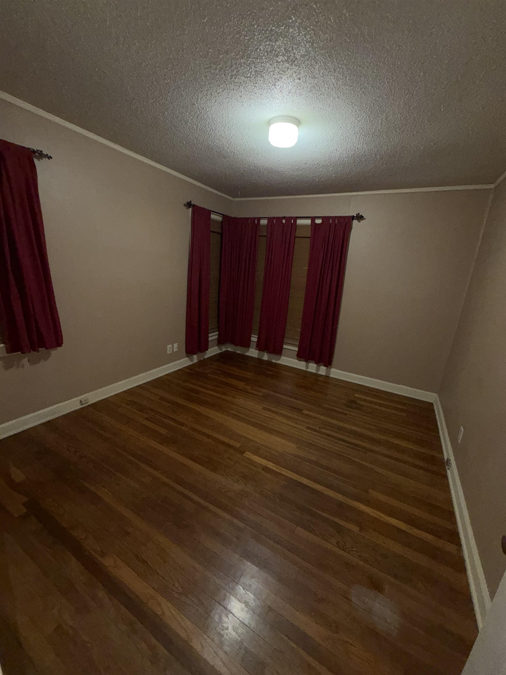 974 Tatum Road Memphis, TN 38122 - Photo 5 of 11 Unfurnished room with dark wood-style flooring and a textured ceiling