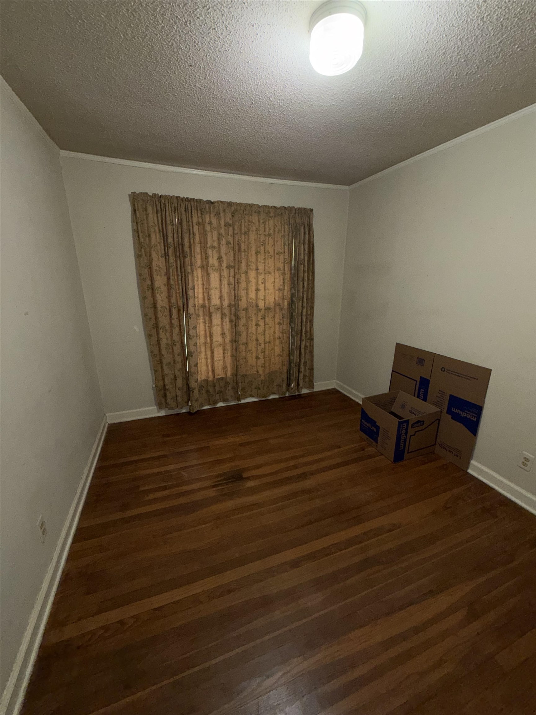 974 Tatum Road Memphis, TN 38122 - Photo 6 of 11 Unfurnished room with a textured ceiling and dark wood finished floors