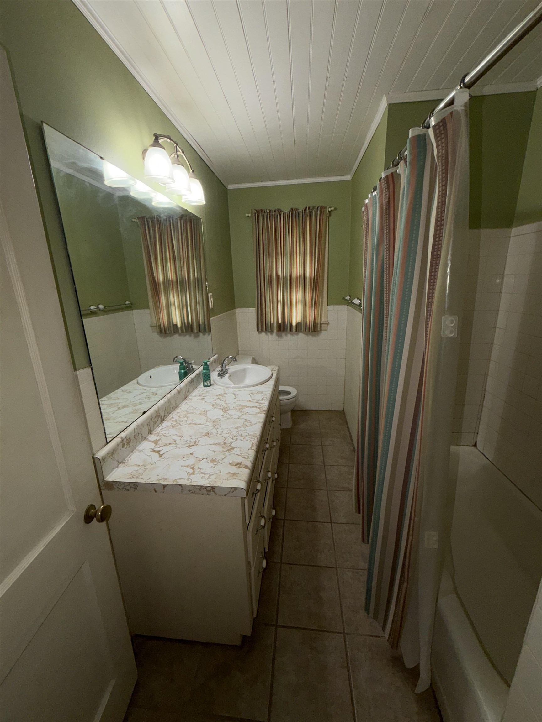 974 Tatum Road Memphis, TN 38122 - Photo 9 of 11 Bathroom featuring vanity, wainscoting, ornamental molding, tile walls, and wooden ceiling