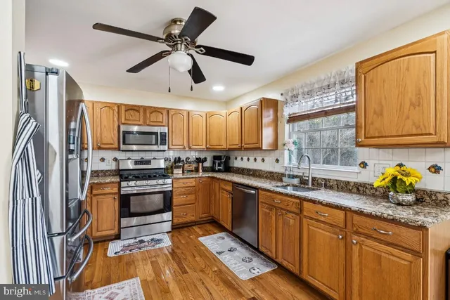 a kitchen with a sink a cabinets and wooden floor