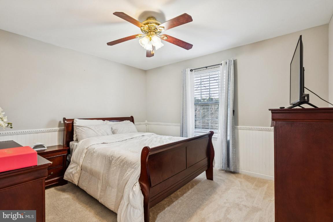 902 Rural Avenue Voorhees, NJ 08043 - Photo 14 of 25 a bedroom with a large bed and a chandelier