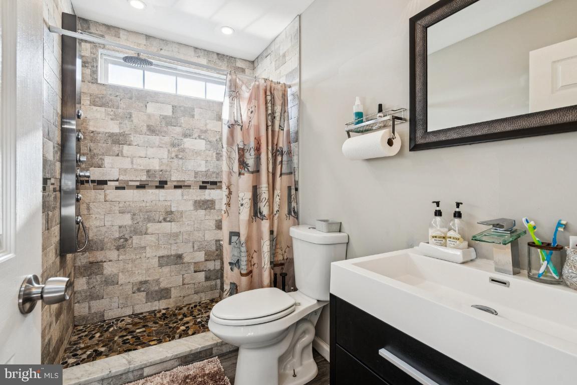 902 Rural Avenue Voorhees, NJ 08043 - Photo 16 of 25 a bathroom with a sink a toilet and shower